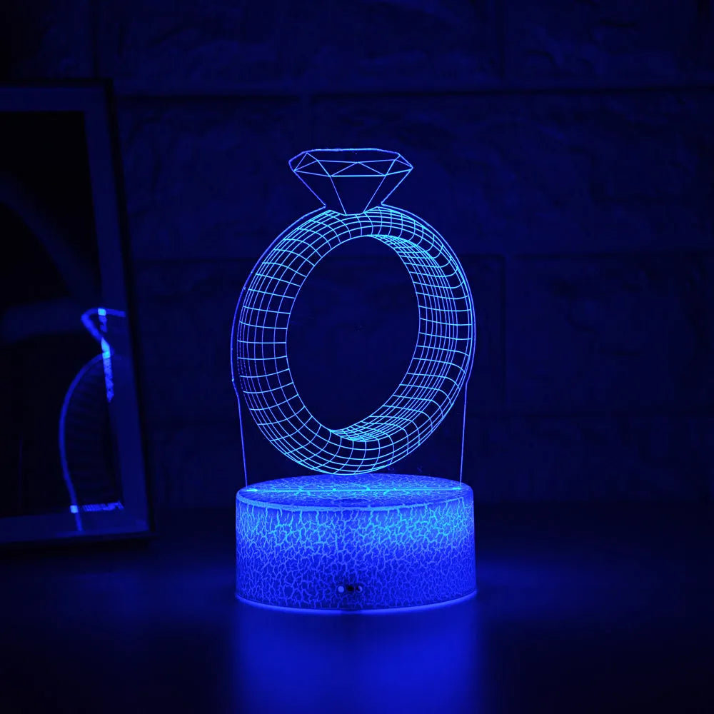 3D diamond ring LED night light with colour-changing acrylic panel on ABS plastic base.