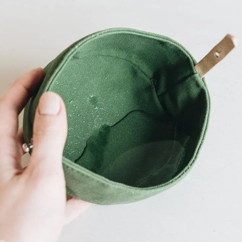 Waterproof foldable travel dog bowl in oil wax canvas, round 150x75mm, shown in green or grey
