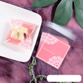 Pink self-adhesive plastic packaging bags for handmade soap, shown with dimensions 7cm by 7cm.