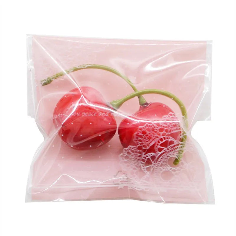 Pink self-adhesive plastic packaging bags for handmade soap, shown with dimensions 7cm by 7cm.