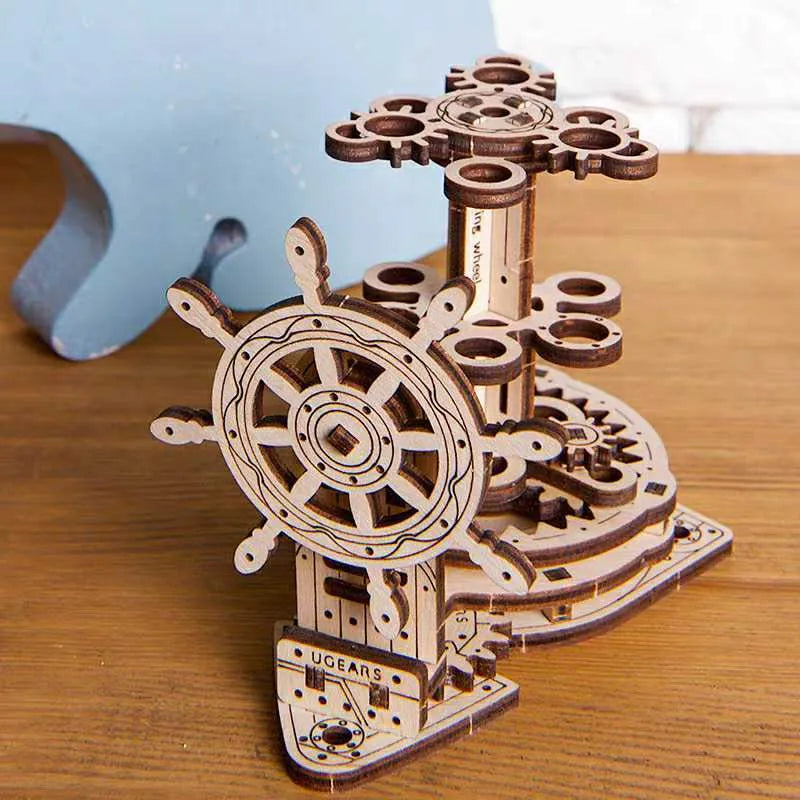 Wooden steering wheel model pen holder rotating on a desk with pens.