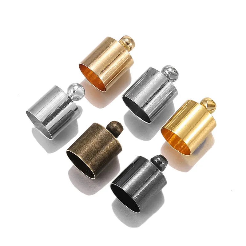 Assorted copper pendant caps in gold, silver, bronze and black finishes, showing weight, bell and tassel styles.