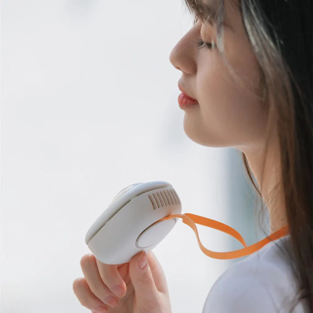 White portable hanging neck fan with USB charging cable and three-speed controls