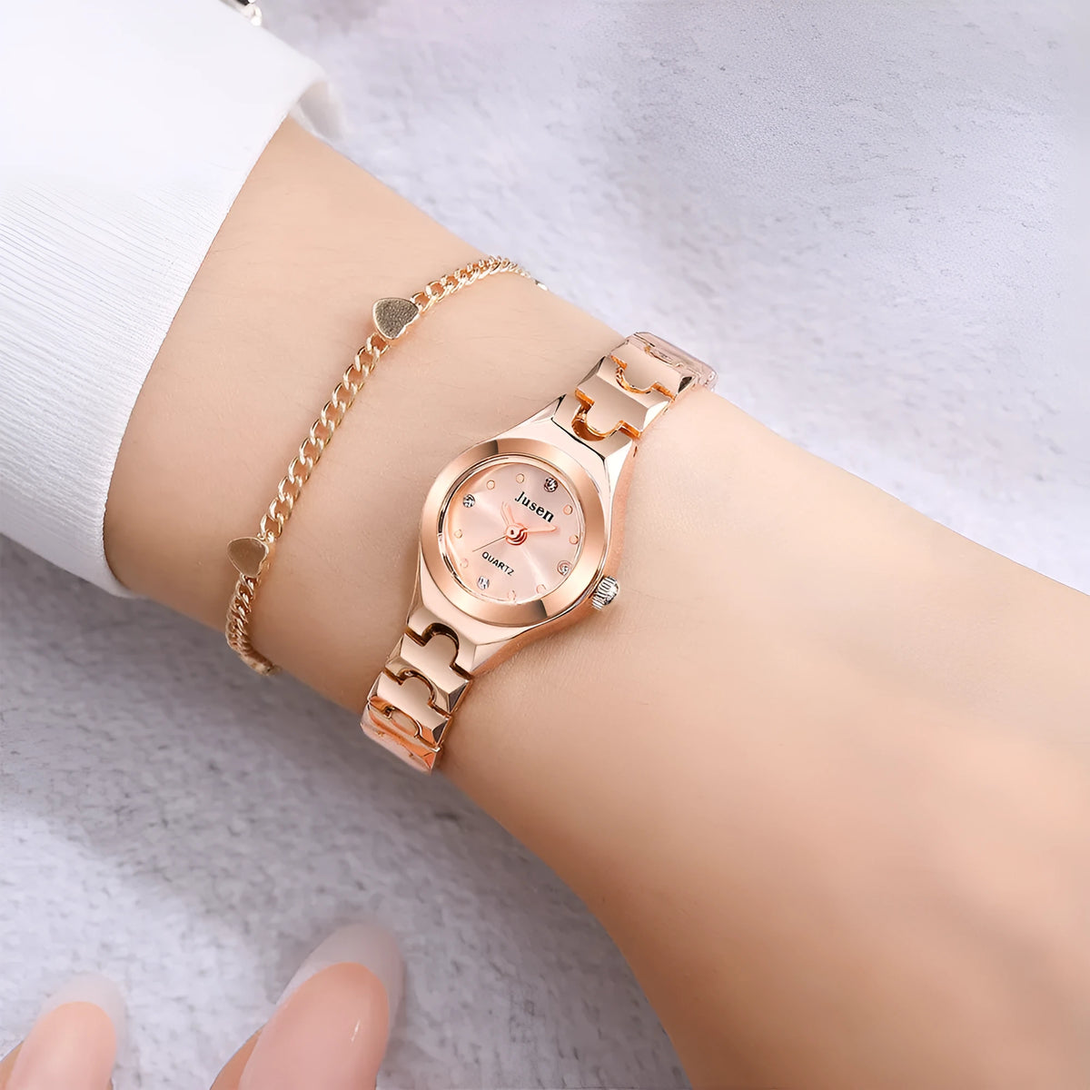 Small round ladies quartz bracelet watch with alloy case, alloy strap, stainless steel horseshoe buckle, and 20mm dial.