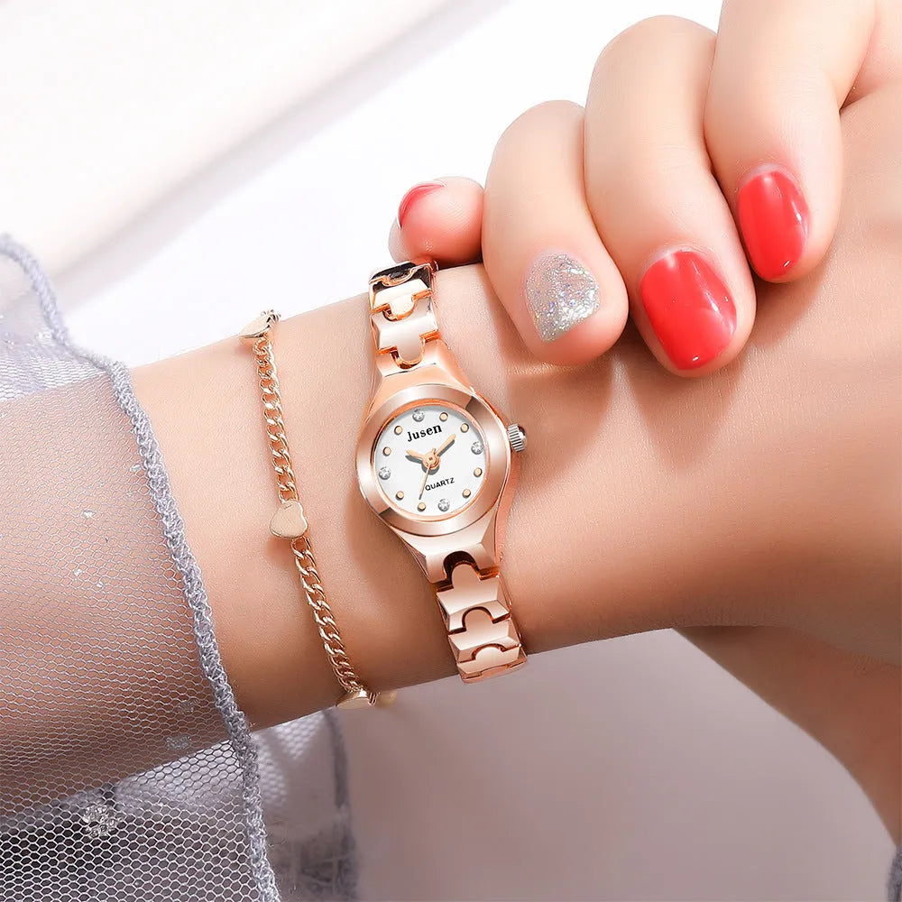 Small round ladies quartz bracelet watch with alloy case, alloy strap, stainless steel horseshoe buckle, and 20mm dial.