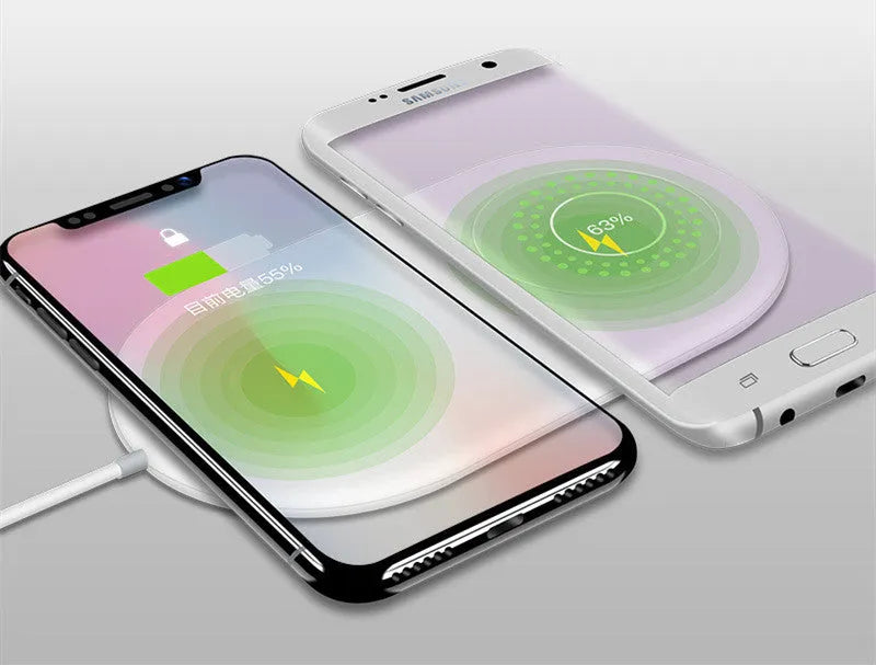 White circular wireless charger showing two smartphones charging simultaneously on its surface