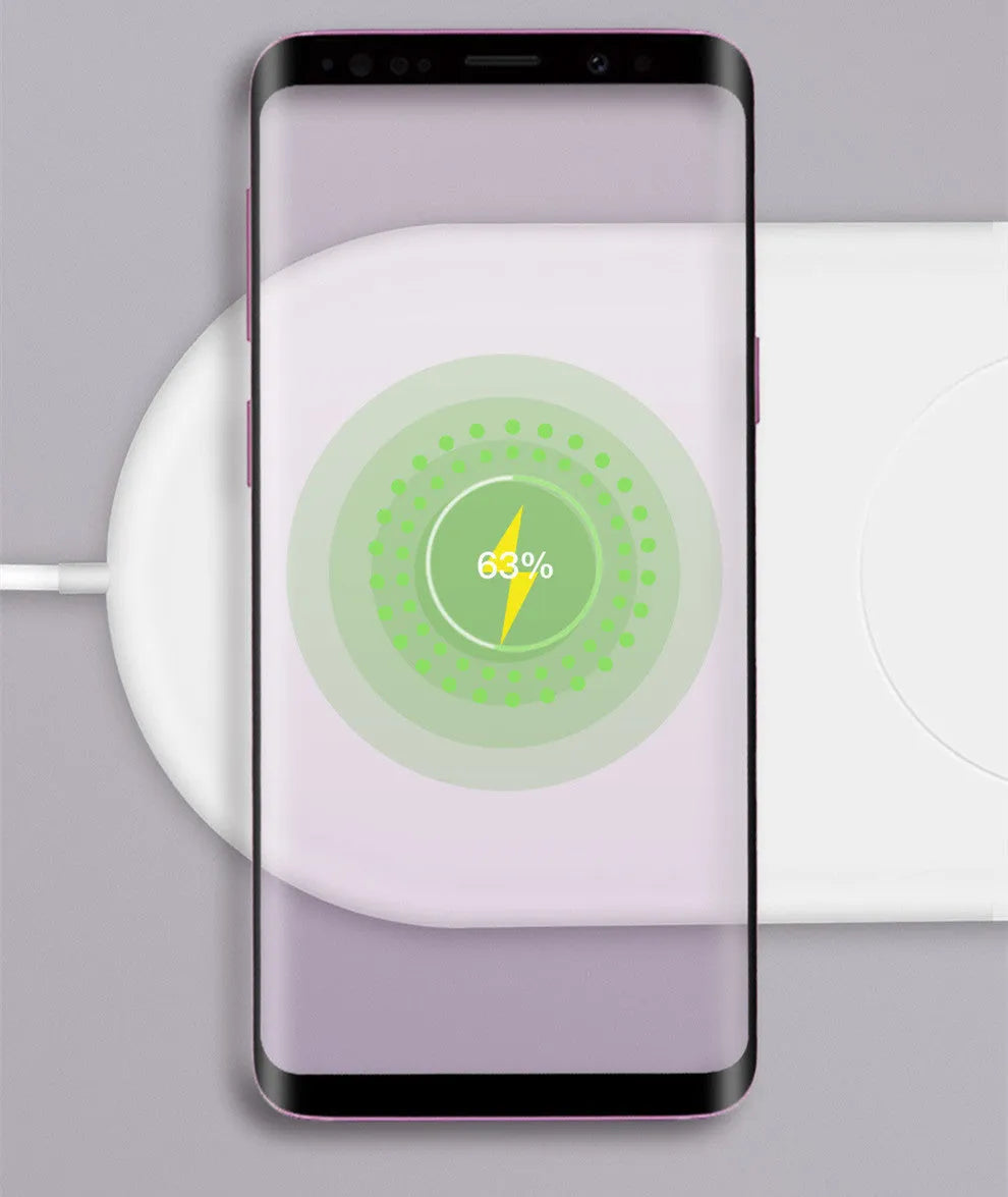 White circular wireless charger showing two smartphones charging simultaneously on its surface