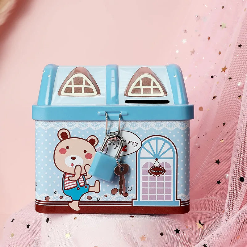 Blue house-shaped tinplate piggy bank on desktop with coins