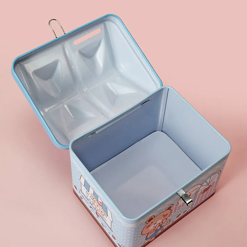 Blue house-shaped tinplate piggy bank on desktop with coins