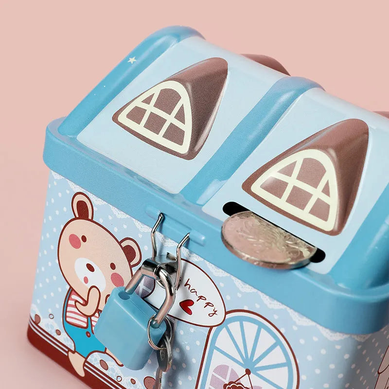 Blue house-shaped tinplate piggy bank on desktop with coins