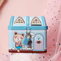 Blue house-shaped tinplate piggy bank on desktop with coins