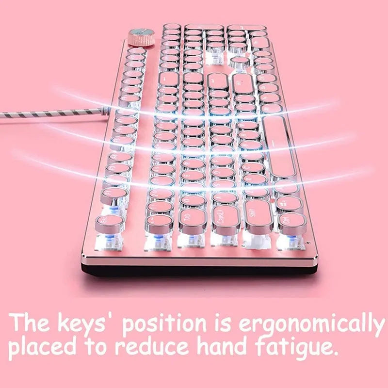 Queen Lipstick mechanical keyboard with green switches, silver bottom, and pink backlight on desk