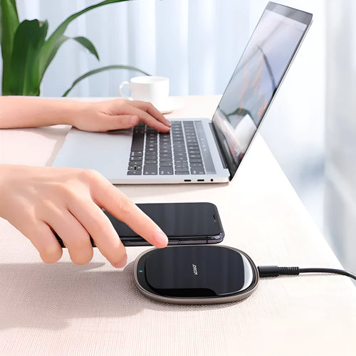 Black 15W square wireless charging pad with a glass top on a desk
