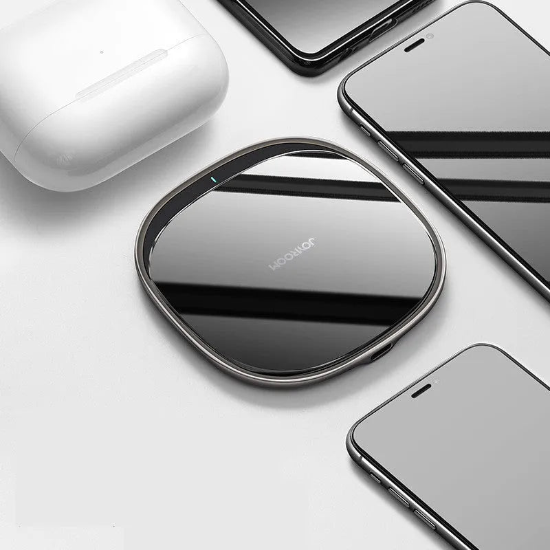 Black 15W square wireless charging pad with a glass top on a desk