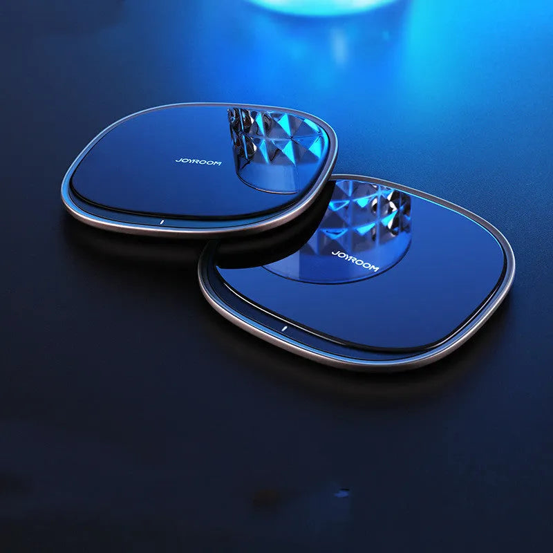 Black 15W square wireless charging pad with a glass top on a desk