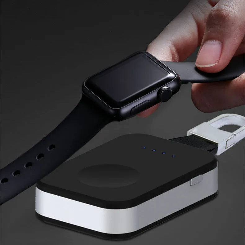Black ABS Apple Watch wireless charging power bank on a keyring, shown next to an Apple Watch.