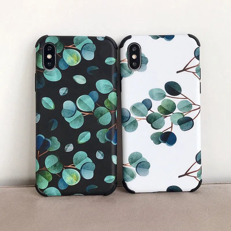 Black silicone iPhone case featuring a printed leaf design, shown fitted to a phone.