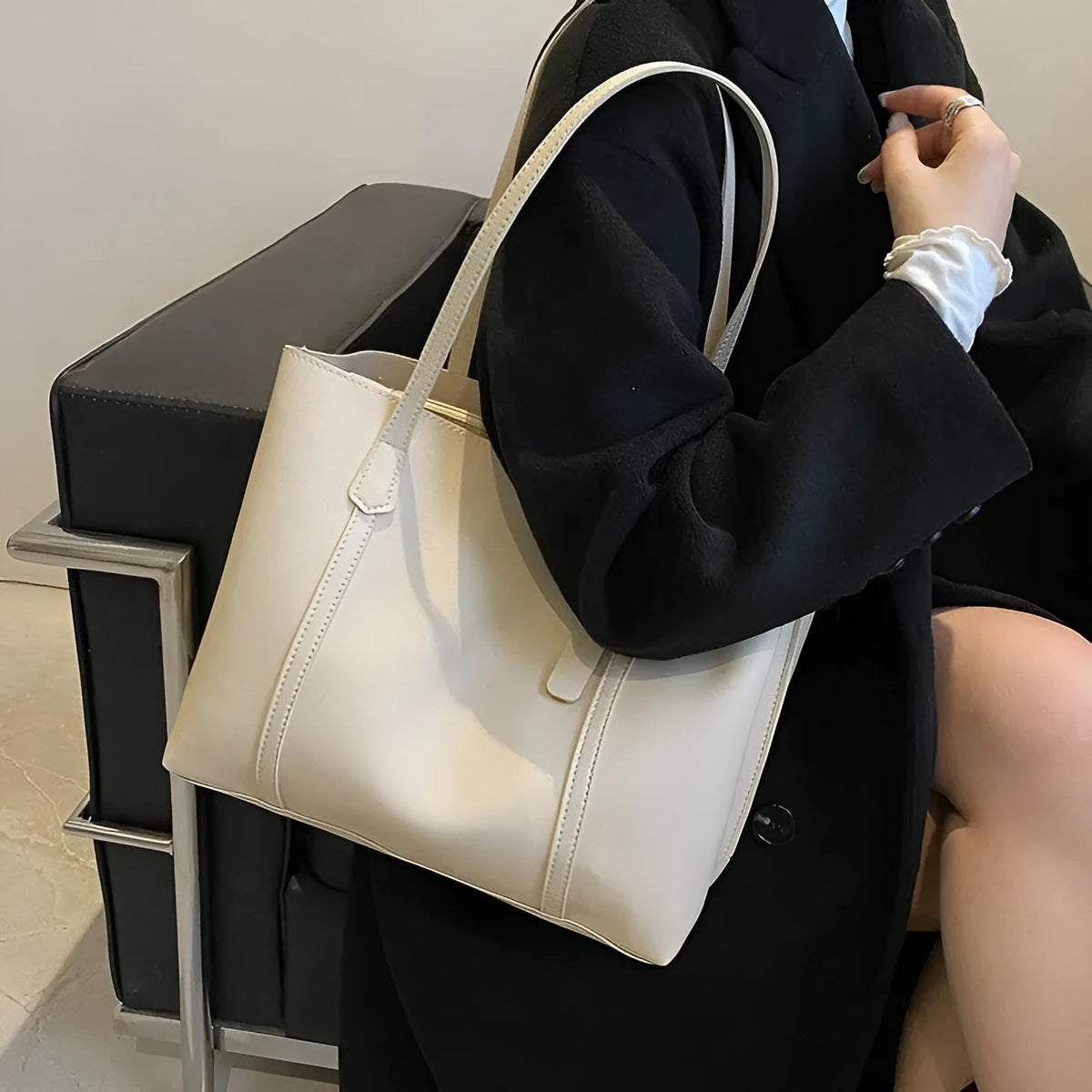 Large capacity soft leather tote bag in beige with synthetic leather lining and double shoulder straps.