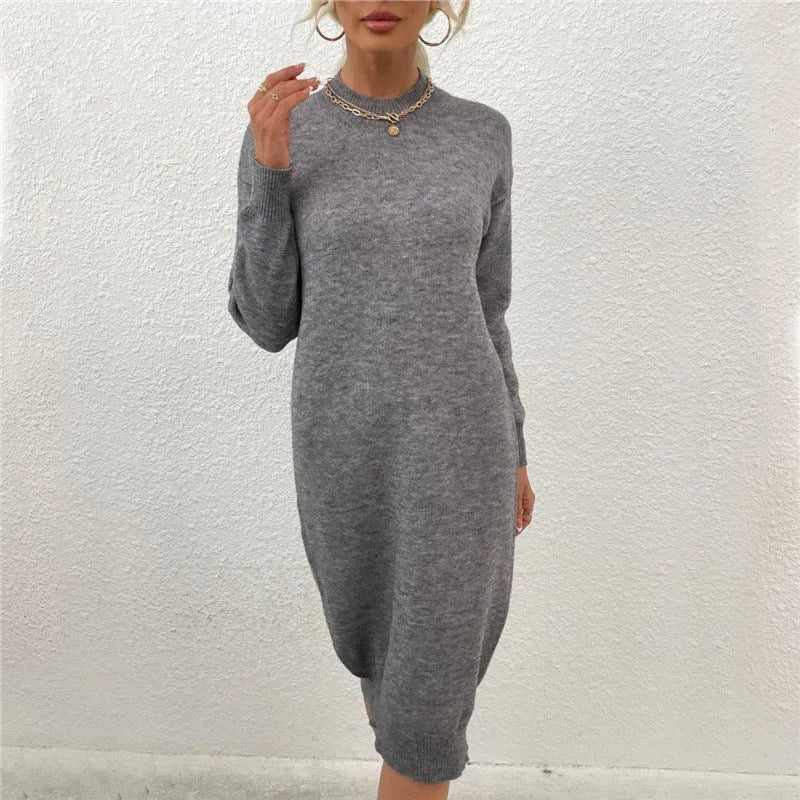 Grey women's crew neck casual acrylic sweater on a hanger.