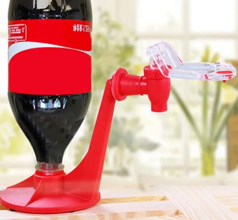 Red plastic soda dispenser attached to 2-litre bottle showing push-button mechanism