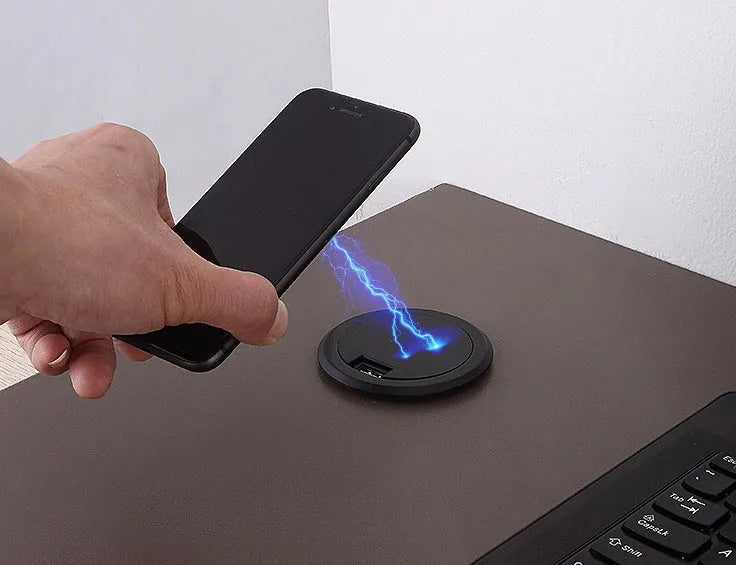 Black round 60mm diameter wireless phone charger for embedding into desk or table surface.
