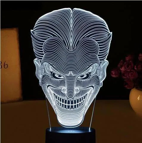 3D acrylic LED table lamp with USB cable and remote control on a desk