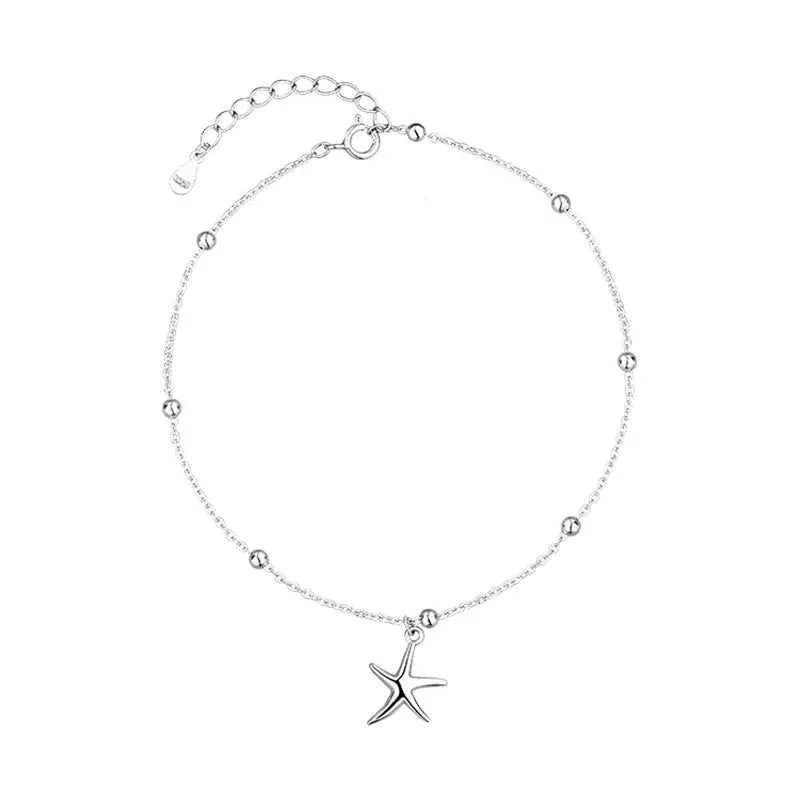 Close-up of a sterling silver starfish charm anklet with a round beaded chain.