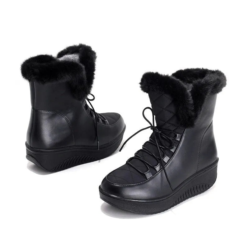 Women's black lace-up winter ankle boots with a platform sole on a white background.