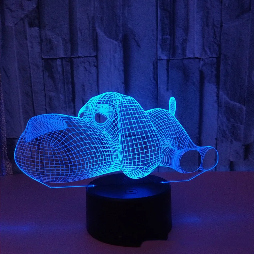 3D illusion dog lamp glowing in multiple colours on a desk with USB cable