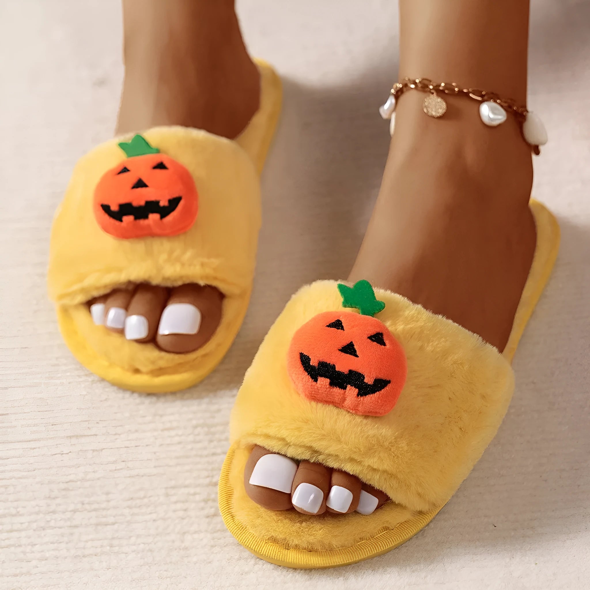Halloween cartoon pumpkin design open-toe plush slippers on a white or yellow synthetic fur upper with PVC sole.