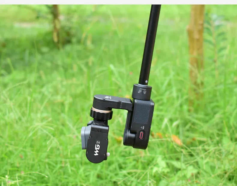 Black retractable aluminium selfie stick extended to full length showing tripod mount.