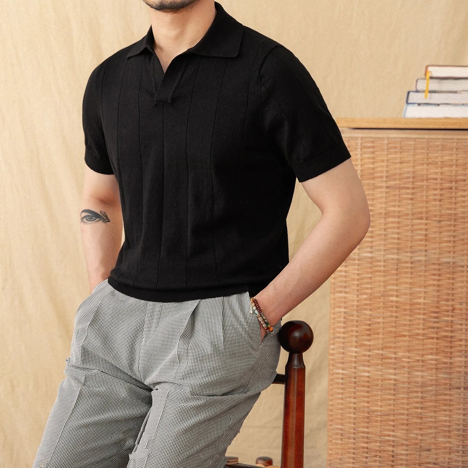 Man's purple short sleeve polo shirt with seagull collar and sunken stripe knitted texture.