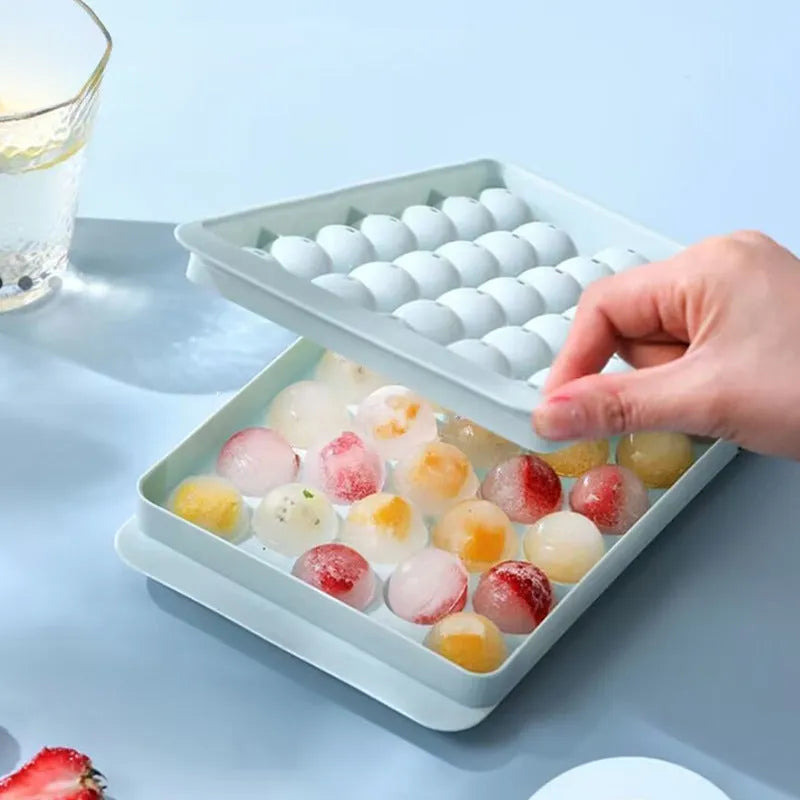 Blue silicone ice cube tray with lid showing 33 round grids for homemade ice