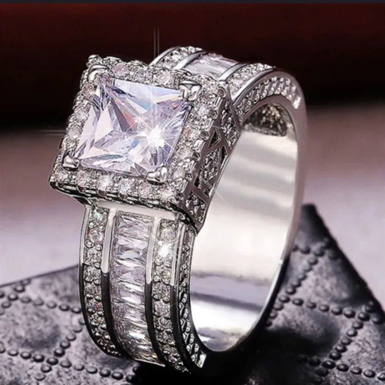 Women's geometric alloy ring with electroplated gold or white finish showing round design elements and available in sizes 5-13