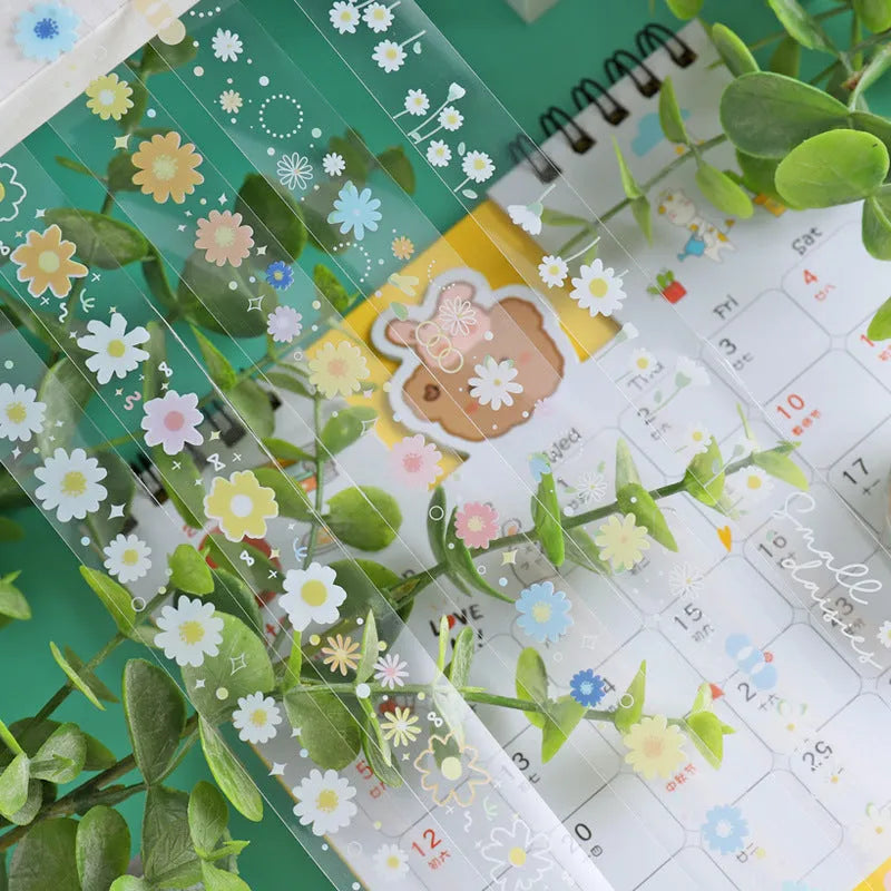 Five rolls of transparent decorative washi tape with Midsummer Daisy pattern, each 1.5cm wide