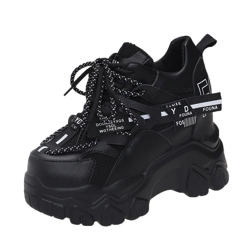 Women's white mesh platform trainers with cross-strap and chunky rubber sole on a neutral background.