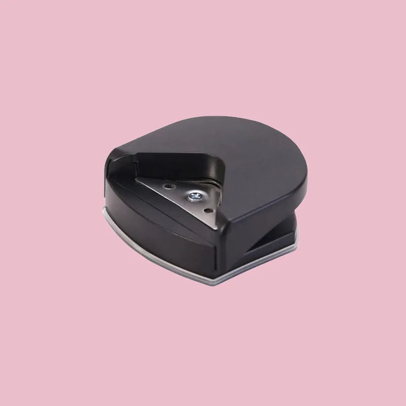 Corner cutter for paper cards and photos, plastic and metal, 5.8cm by 5.4cm by 2.5cm, in black, pink, or blue