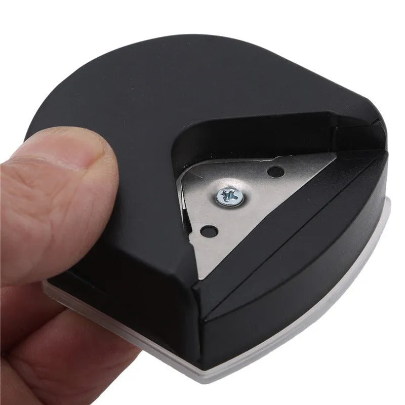 Corner cutter for paper cards and photos, plastic and metal, 5.8cm by 5.4cm by 2.5cm, in black, pink, or blue