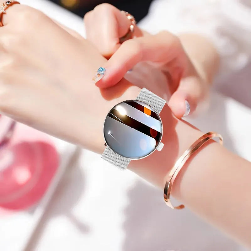 Women's smart watch with circular colour screen and metal wrist strap on wrist