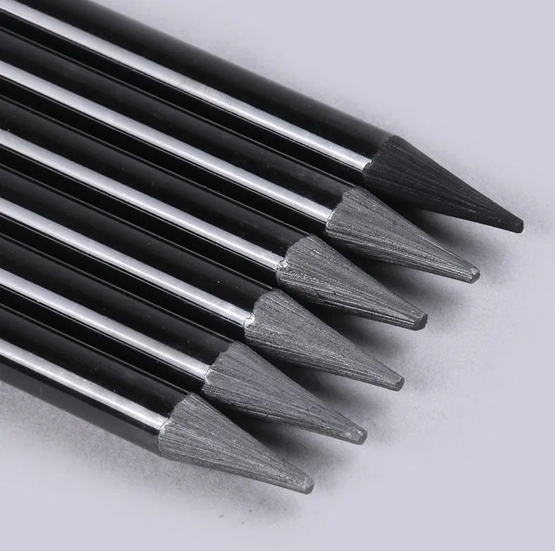 Carbonised and graphite drawing pencil set of nine in a wooden case, showing six graphite and three carbonised pencils.
