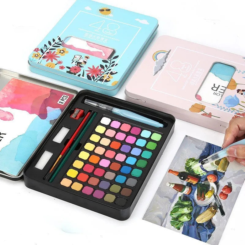 Metal tin open to show 48 pans of solid watercolour paint in various colours including black, pink, and blue.