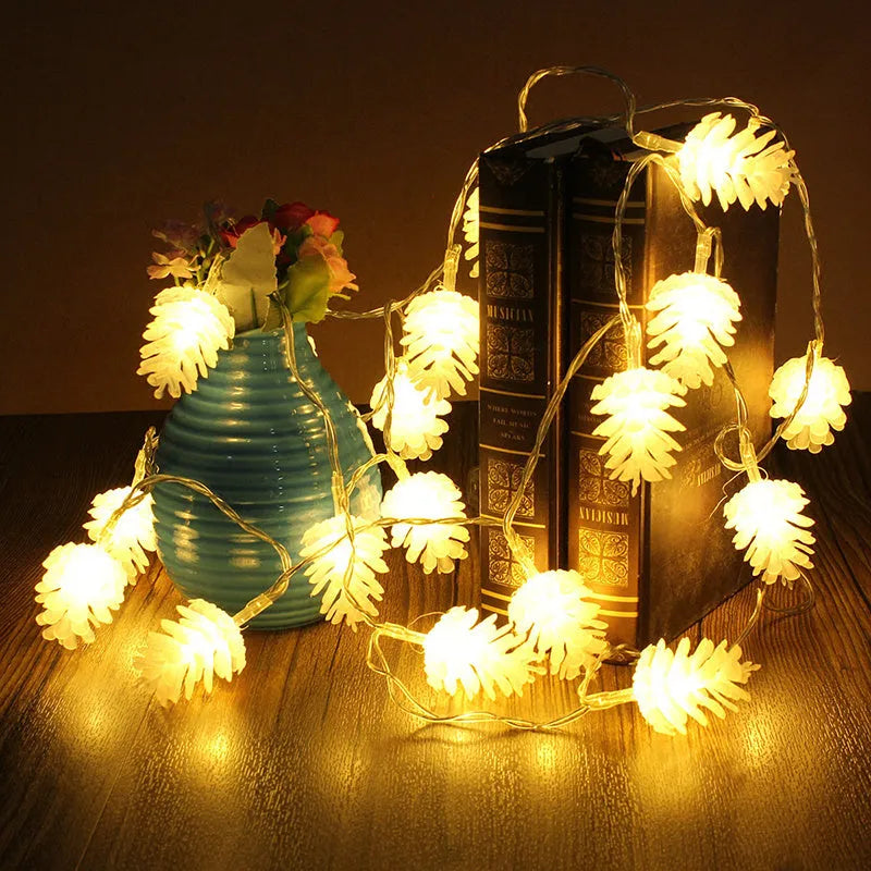 Warm white LED pine cone light string powered by AA batteries, shown in a 10-light or 20-light option for decorative use.