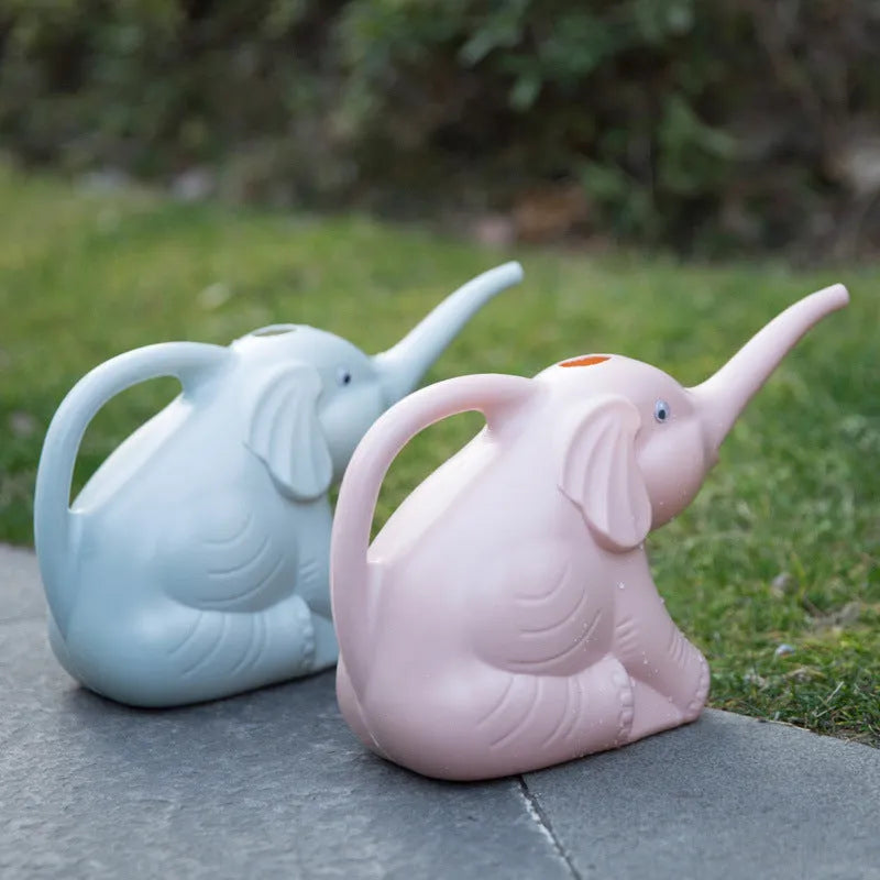 Pink children's watering can shaped like a sitting baby elephant with a long spout and bottle-shaped handle.