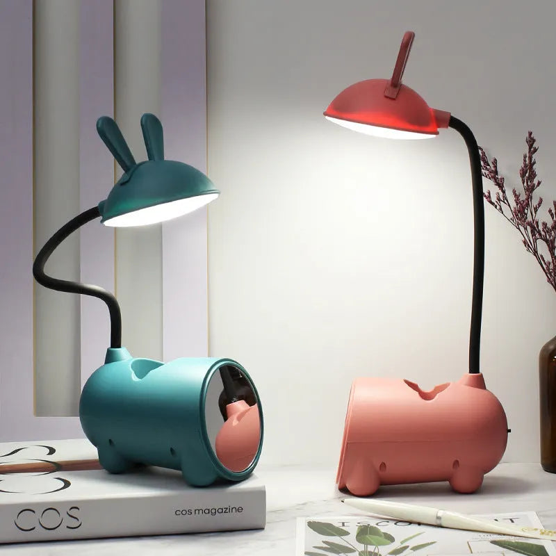 Cartoon-style USB-powered table lamp with pen container in green, blue, or pink colour