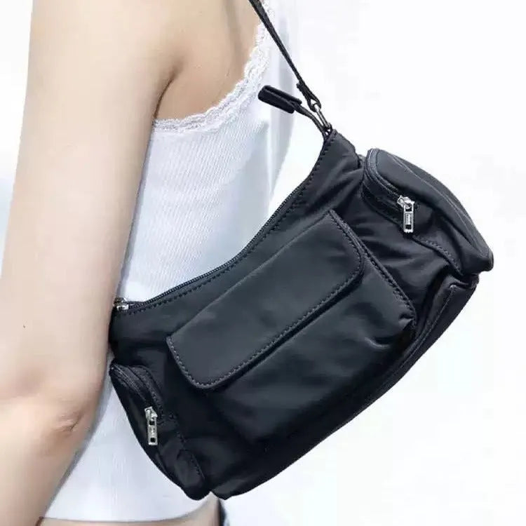 Black nylon lightweight double pocket women's shoulder bag showing side line detail