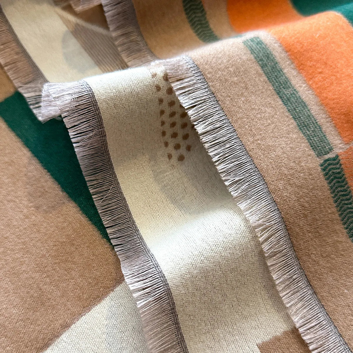 Beige imitation cashmere scarf draped to show its 185cm length and 65cm width.