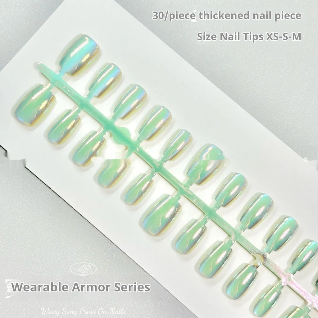 Set of electroplated Cat's Eye false nails with aurora shine in short square stiletto shapes on a clear stand.