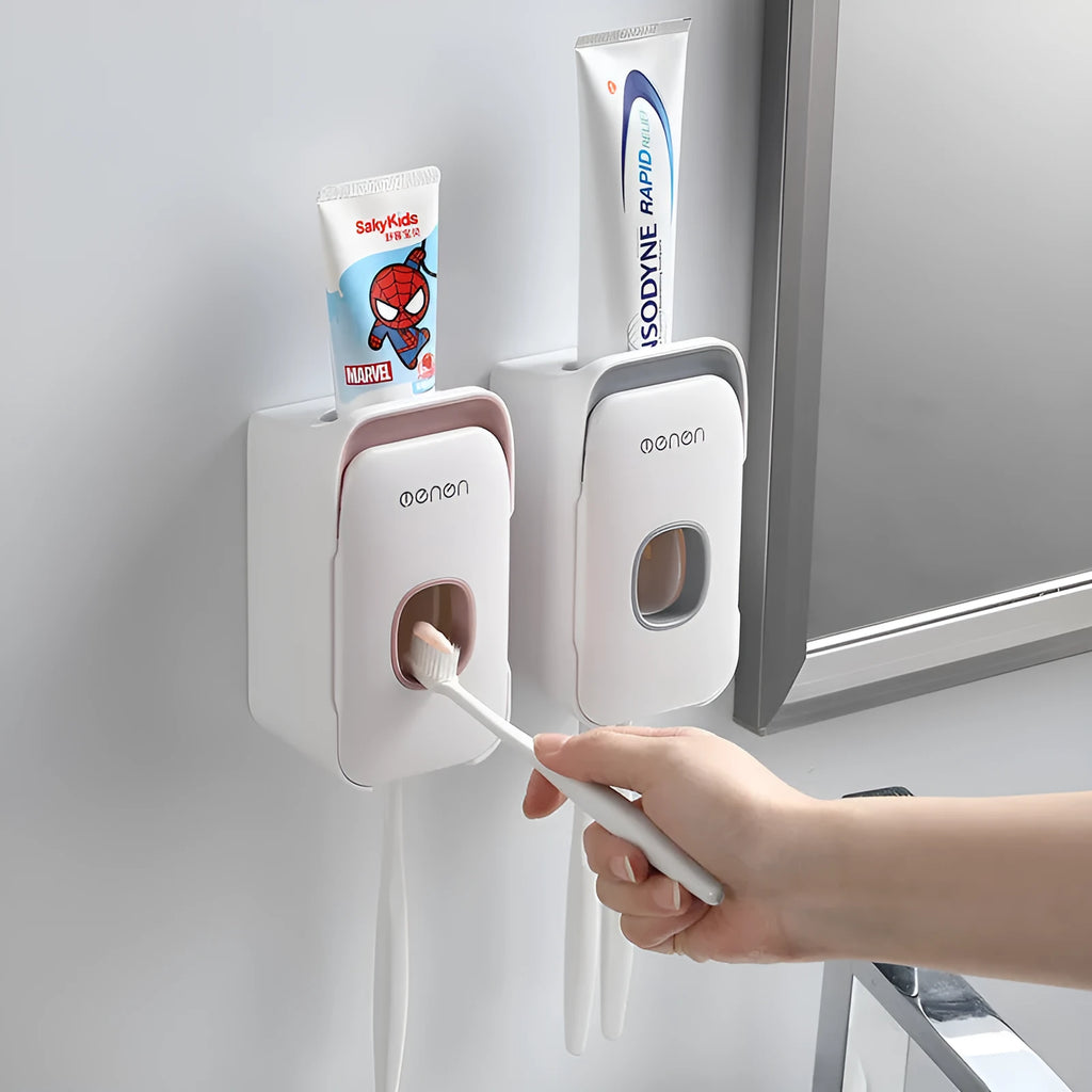 Wall-mounted automatic toothpaste dispenser in blue, grey, and pink colours