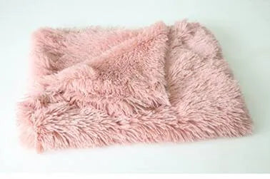 Soft dark grey long plush dog blanket shown next to a large dog in a home setting.