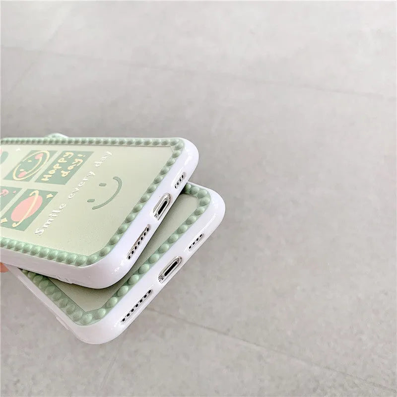 Green TPU iPhone case with geometric pattern and smiley face design in a polka dot frame.